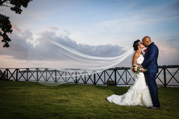 Couple kissing at a seaside wedding